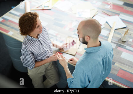 Creative designers discussing new project in studio Stock Photo