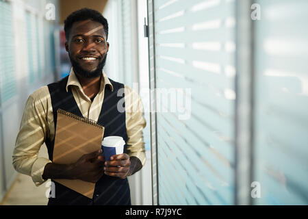 Smiling black designer with sketchpad Stock Photo