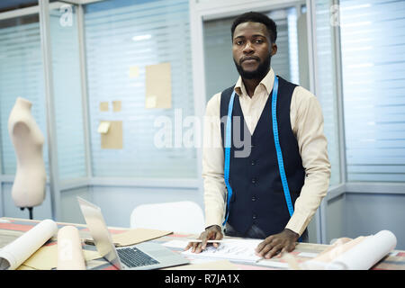Serious dressmaker working in own studio Stock Photo
