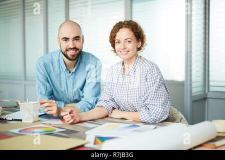 Happy young colleagues working on design Stock Photo