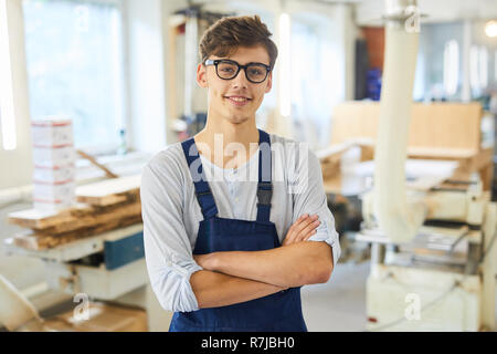 Smiling young joiner in uniform Stock Photo