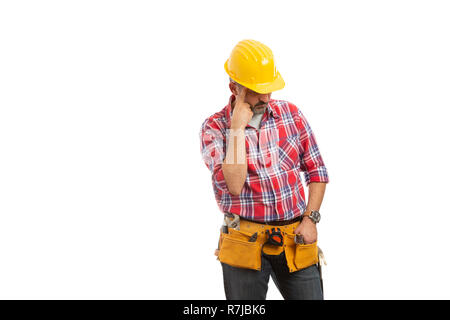 Thoughtful constructor planning while looking down with index finger touching forehead isolated on white background Stock Photo