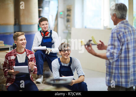 Excited carpentry students laughing during interesting class Stock Photo