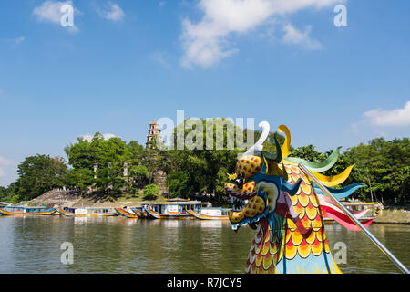 View of Thien Mu Pagoda from a tourists' dragon boat sailing on the Perfume River. Hue, Thua Thien–Hue Province, Vietnam, Asia Stock Photo