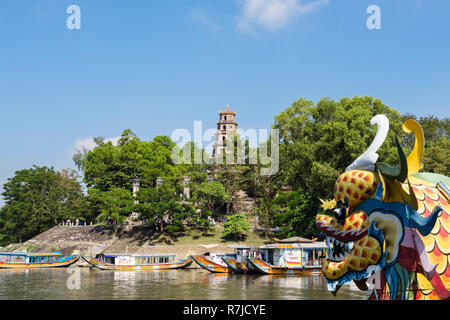 View of Thien Mu Pagoda from a tourists' dragon boat sailing on the Song Huong or Perfume River. Hue, Thua Thien–Hue, Vietnam, Asia Stock Photo