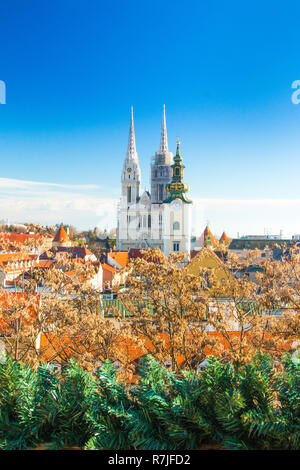 Croatian capital Zagreb, city skyline, catholic cathedral and red roofs in city center, view from Upper town. Christmas advent decoration. Stock Photo