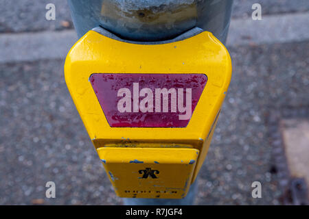traffic light switch in yellow with raindrops at the street Stock Photo