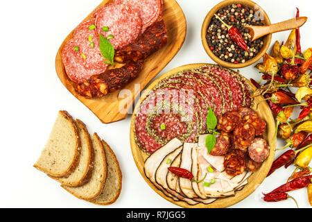 Italian dried salami crusted in ground black pepper. Bacon and sausage for food. Traditional unhealthy food. Stock Photo