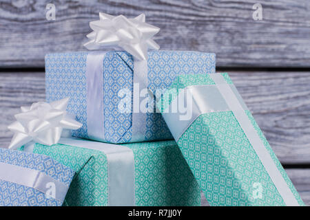 Gift boxes background. Festive gift boxes in blue and turquoise paper on vintage background. Beauty and elegance of gifts decor. Stock Photo