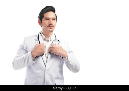 Young asian doctor man with lab coat and stethoscope posing isolated over white background Stock Photo