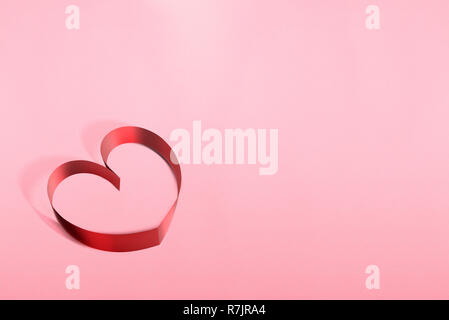 Ribbons shaped as hearts over pink background. Love concept and Valentines day Stock Photo