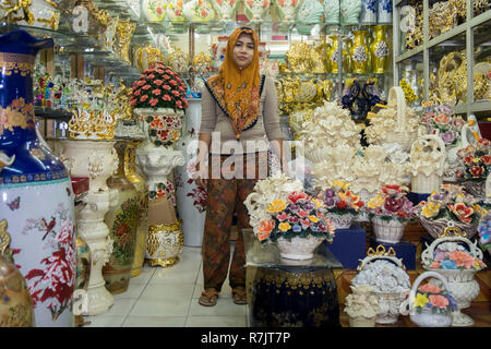 A Muslim woman store owner in her fancy shop in Pekanbaru, Indonesia Stock Photo