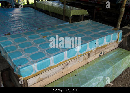 Vinyl tableclothes, recycling old advertising signs in Pekanbaru, Indonesia Stock Photo