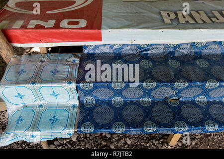 Vinyl tableclothes, recycling old advertising signs in Pekanbaru, Indonesia Stock Photo