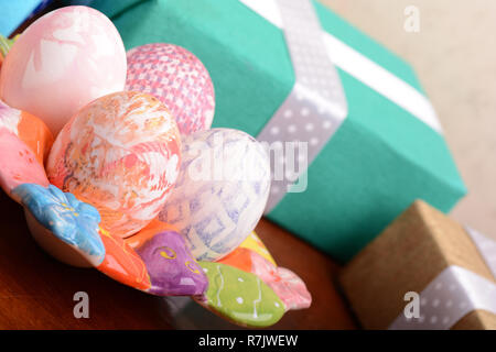 Handcrafted easter eggs close up, gift boxes , ribbons and decoration Stock Photo
