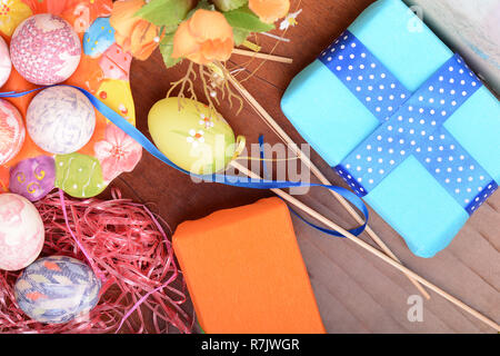 Handcrafted easter eggs close up, gift boxes , ribbons and decoration Stock Photo