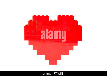 Red heart made of toy building bricks, viewed from the front. Isolated on white background. Stock Photo
