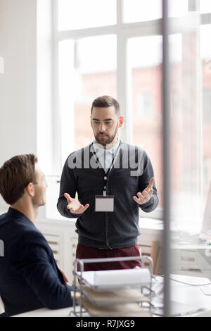 Portrait of two men discussing startup project while working in modern office Stock Photo