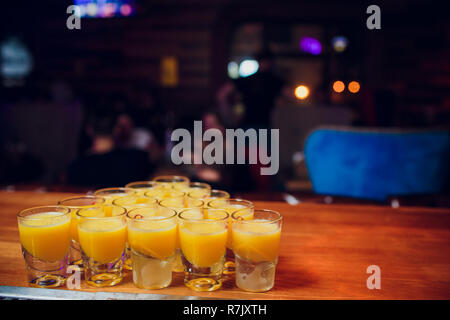 Shots on a bar counter top laid out with a billiard pyramid Stock Photo