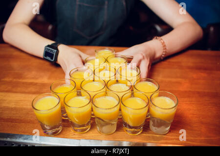 Shots on a bar counter top laid out with a billiard pyramid Stock Photo