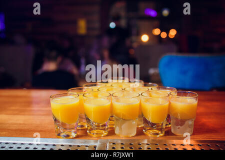 Shots on a bar counter top laid out with a billiard pyramid Stock Photo