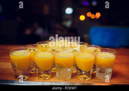 Shots on a bar counter top laid out with a billiard pyramid Stock Photo