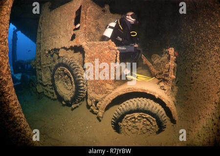 Scuba diver looking at truck on shipwreck 'SS Thistlegorm', Red Sea, Egypt Stock Photo