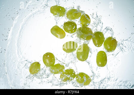 Green Grapes Water Splash on white background Stock Photo