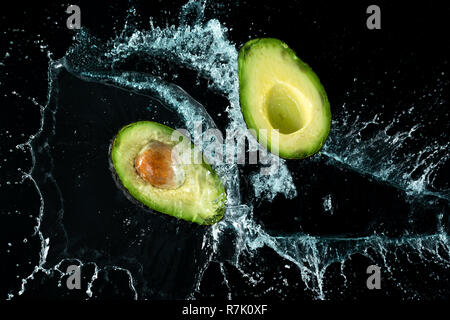 Avocado Water Splash on black background Stock Photo