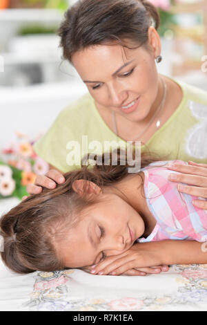 Portrait of mother awakening daughter who sleeping at table Stock Photo