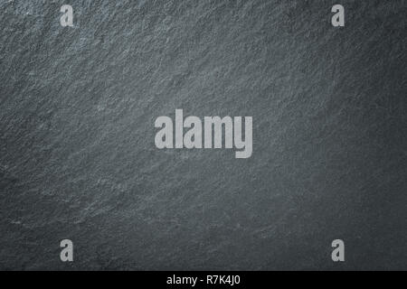 Light gray background of natural slate. Texture of black stone closeup. Stock Photo