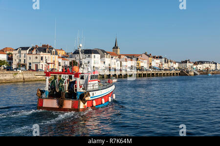 Fishing trawler returning to harbor with the dock of la Chaume in the background (Les Sables d'Olonne, France) Stock Photo