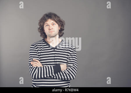 Upset gloomy handsome male feeling unhappy missing chance buy tickets to concert. Portrait of displeased offended cute hispanic man, frowning and sulk Stock Photo