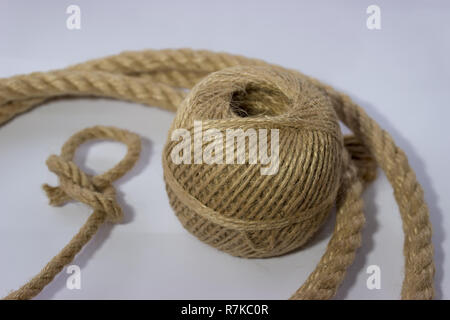 https://l450v.alamy.com/450v/r7kc0r/thin-twine-tangled-in-a-ball-and-rope-witk-dragon-loop-there-are-several-threads-of-rope-around-the-ball-r7kc0r.jpg