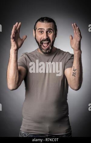 portrait of surprised man studio shot grey background Stock Photo