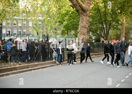 People crossing road during fire drill evacuation Cartwright Gardens, Bloomsbury, London England Britain UK Stock Photo