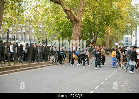 People crossing road during fire drill evacuation, Cartwright Gardens, Bloomsbury, London England Britain UK Stock Photo