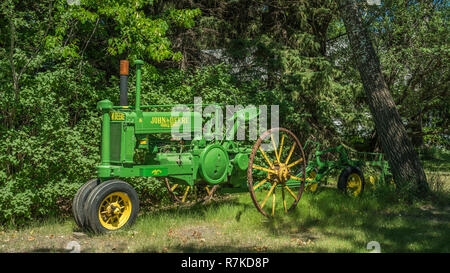 A vintage John Deere tractor and plow near Osterwick, Manitoba, Canada. Stock Photo