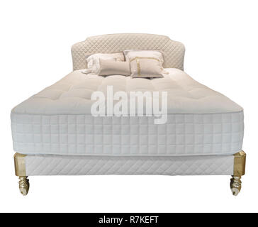 Luxury white modern bed furniture with orthopedic matress and pillows and with leather upholstery headboard . Soft fabric bedclothes. Classic modern furniture on isolated background Stock Photo