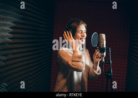 emotional gorgeous woman is concentrated on singing Stock Photo