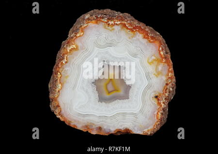 A cross-section of agate. A snow-white chalcedony is interwoven with gray, transparent quartz. Origin: Agouin, Atlas mountains, Morocco. Stock Photo