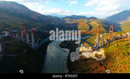 Kunming. 10th Dec, 2018. Aerial photo taken on Dec. 9, 2018 shows the railway arch bridge across the Nujiang River in southwest China's Yunnan Province. With a grand arch bridge erected on Monday morning, Chinese constructors have built the longest-spanning railway arch bridge with a single span of 490 meters. The bridge is a key project of the 220-km-long Dali-Ruili railway which is a key section of the China-Myanmar international railway corridor linking Kunming, the provincial capital of Yunnan, with Yangon of Myanmar. Credit: Xinhua/Alamy Live News Stock Photo