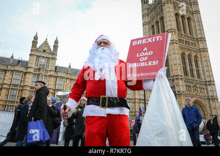 Westminster London, UK, 10th December 2018. Father Christmas has joined the protesters. Activists from both the Remain or 'Anti-Brexit' side, as well as campaigners for 'Leave means Leave ' ,who want to leave the EU, are protesting outside the Houses of Parliament in Westminster with placards, banners and chants. Both sides appear to vocally reject the current Brexit 'deal' offered. Credit: Imageplotter News and Sports/Alamy Live News Stock Photo