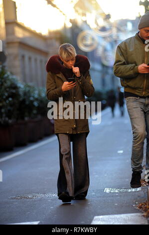 Milan, Elodie Di Patrizi shopping in the center with a friend Elodie Di Patrizi, better known simply as 'ELODIE', the singer who came out of the talent 'FRIENDS' by Maria De Filippi, arrives downtown with a friend she did not want reveal the name. The two armbands walk in via Montenapoleone, browsing through the windows of the boutiques, then look for a shoe store's address on the smartphone to do some shopping. While walking ELODIE is recognized and hobbled by a beggar who asks for alms, she stops and looks in the pockets of money, pulls out a 10 euro bill and gives it to her. He then goes to Stock Photo