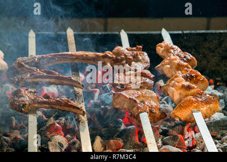 Appetizing meat grilled on skewers. Cooking shashlik. Stock Photo