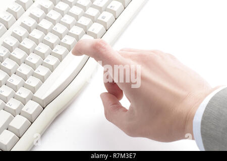 finger hit the button on the old computer keyboard Stock Photo