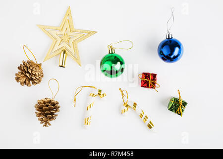 Christmas background with boxes, balls, nuts, and star. Festive holiday decorations on white background. top view Stock Photo
