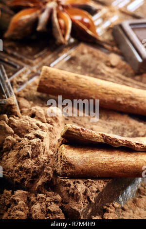 Christmas decor with dark chocolate coffee beans cinnamon nuts and star anise and empty place for text Stock Photo
