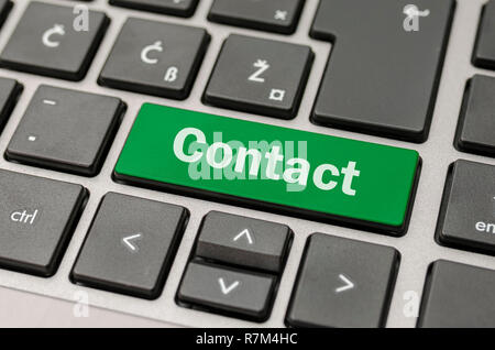 Green Contact button on computer keyboard. Stock Photo