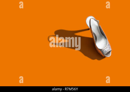 Women's High Heel Shoe on orange Background Stock Photo